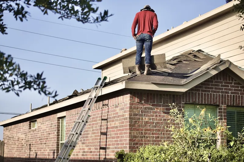Professional roofer working on a residential roof in Hillsdale Park